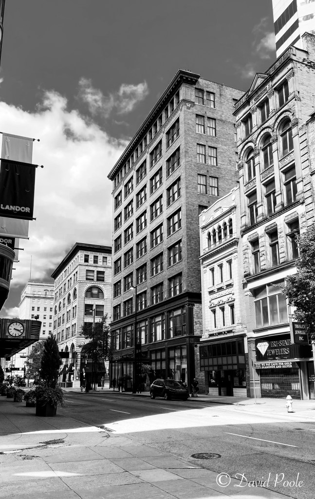 Black and white photo of Lyric Piano Company and Tri-State Jewelers Row storefronts, showcasing historic architecture in downtown Cincinnati